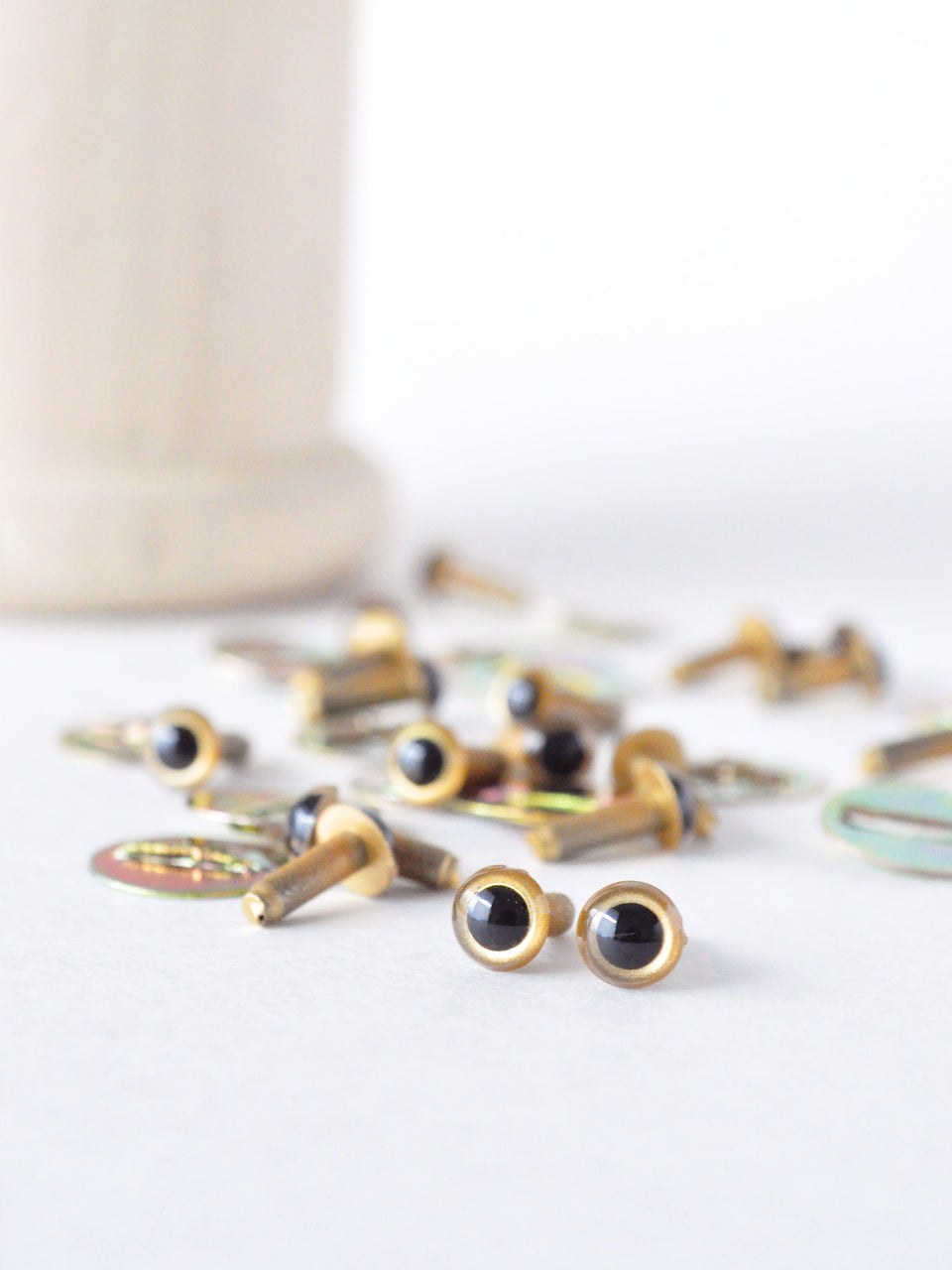 4.5 mm gold safety eyes on a white surface