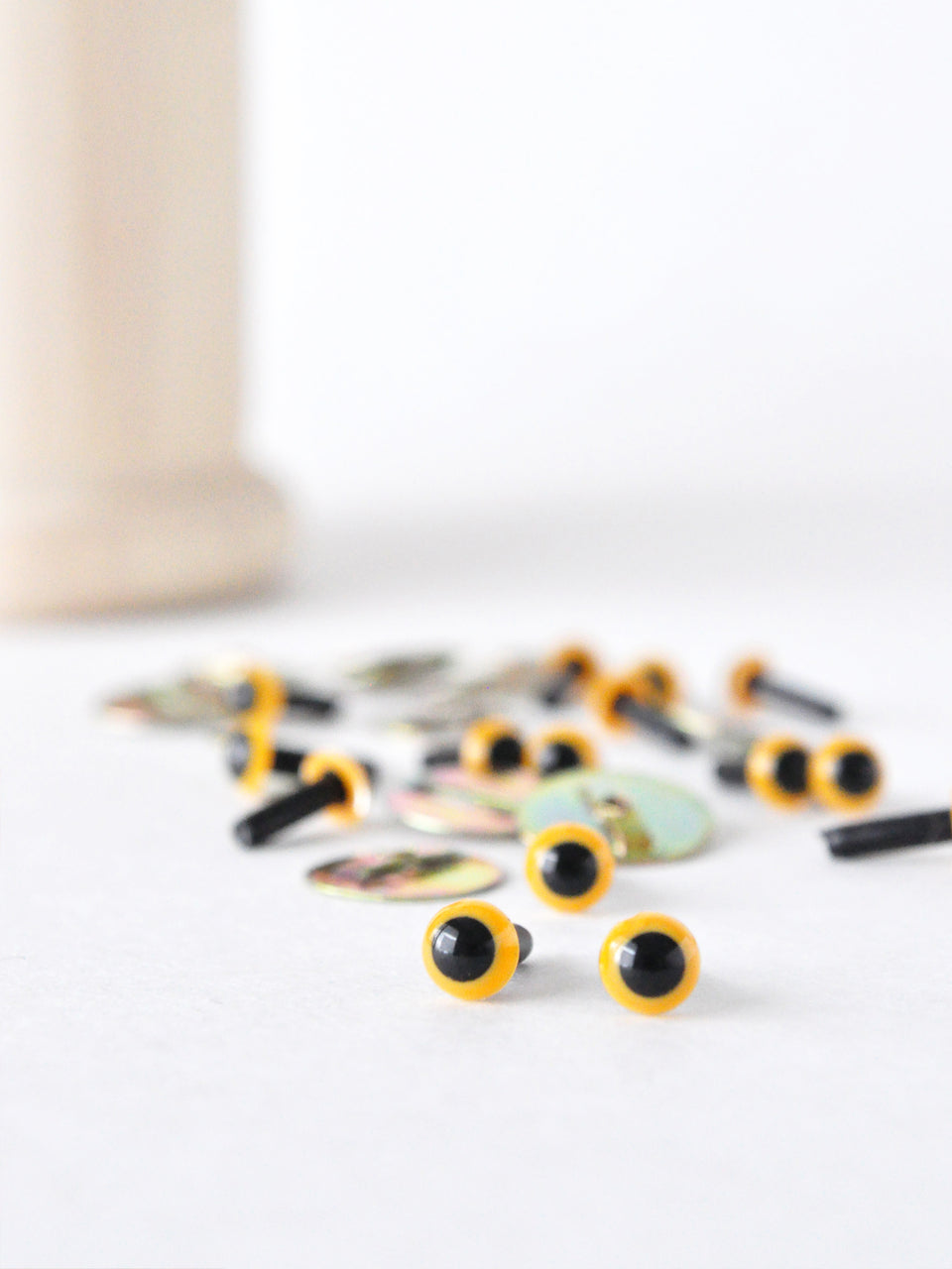 4.5 mm yellow safety eyes with black pupils on a white background