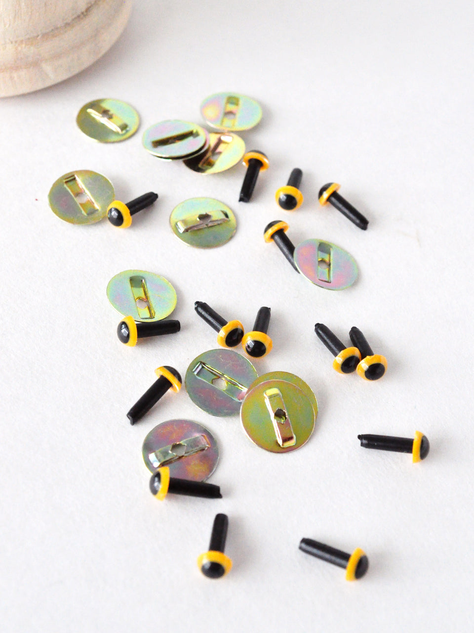 4.5 mm yellow safety eyes with black pupils and metal washers on a white background