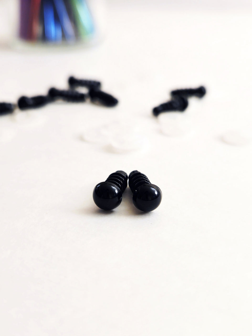 closeup of 6 mm black safety eyes on white background