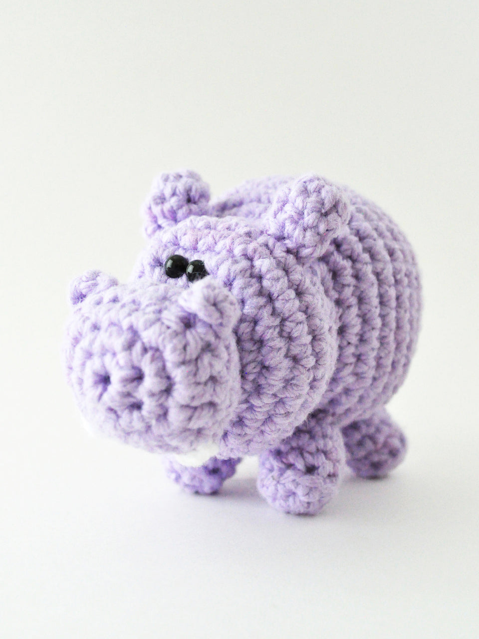 Purple crochet hippo on a white background, amigurumi pattern by The Pudgy Rabbit