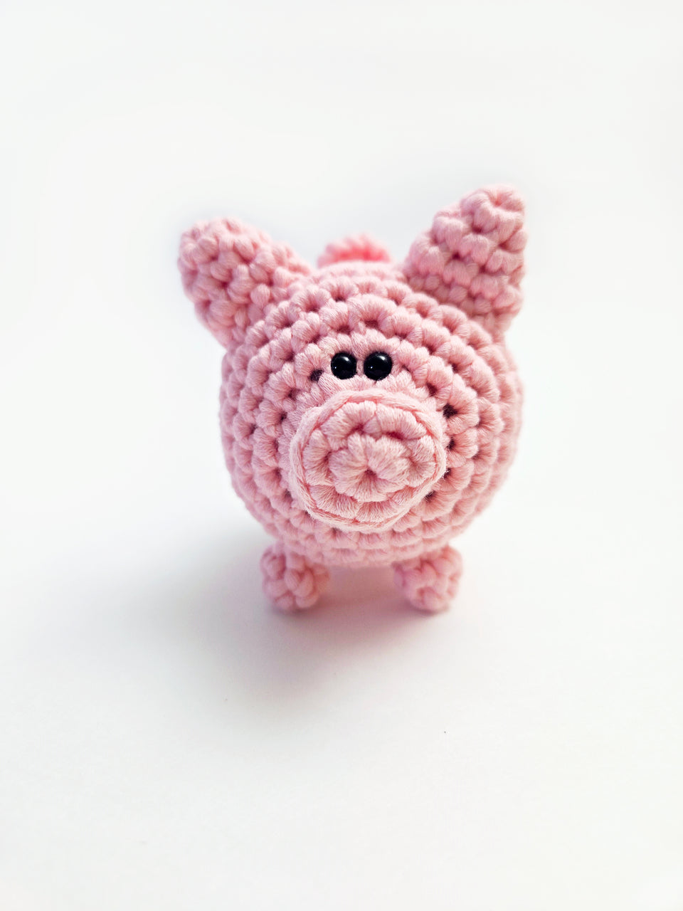 Front view of pink crochet pig