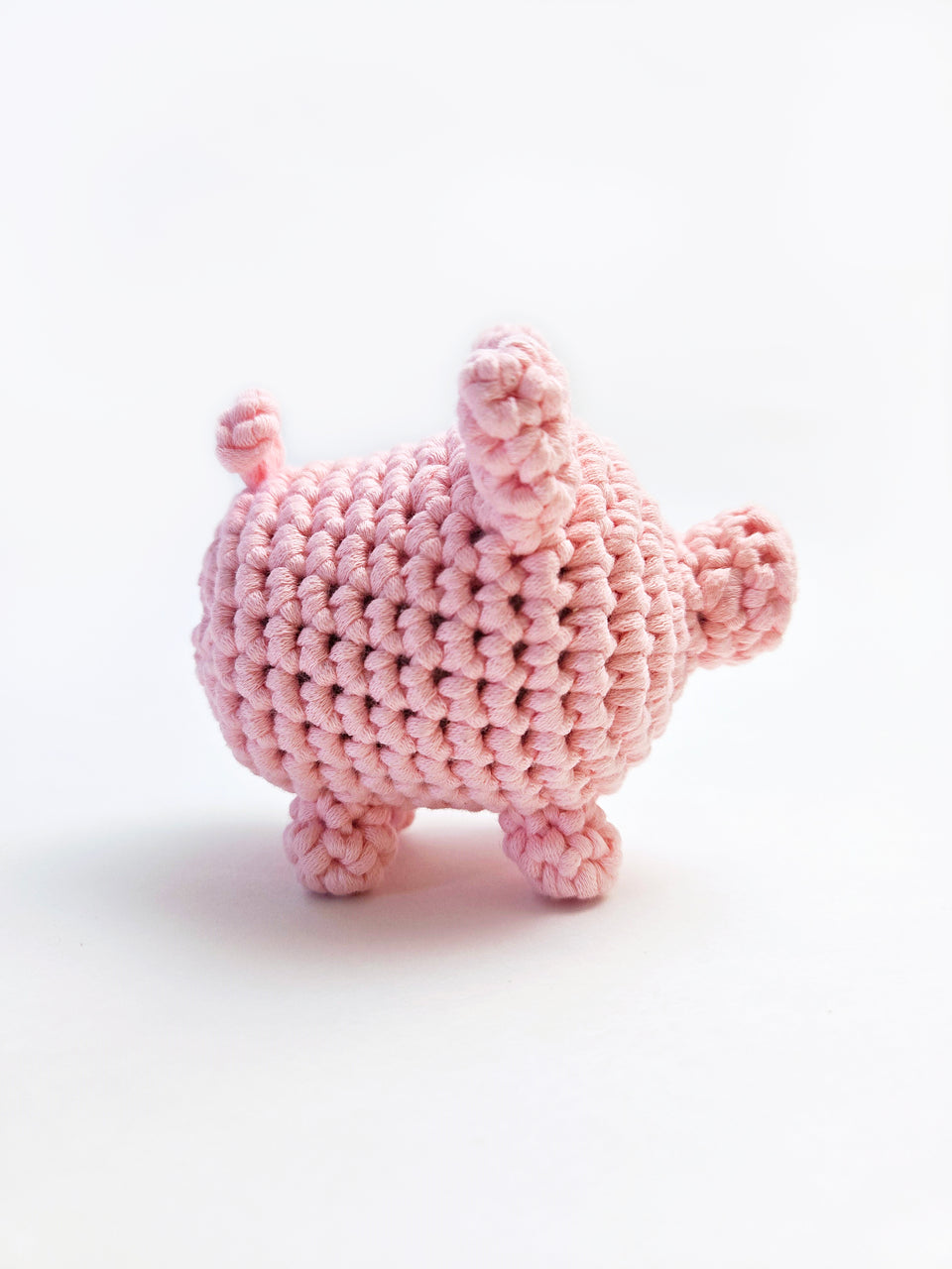 Side view of pink pig amigurumi