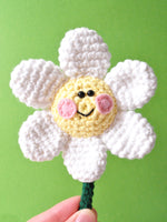 crochet daisy with pink cheeks and a smile