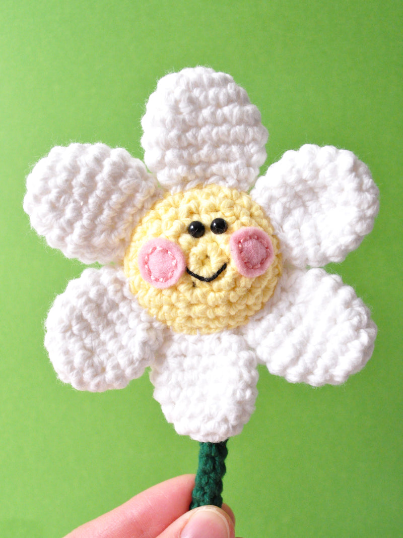 crochet daisy with pink cheeks and a smile