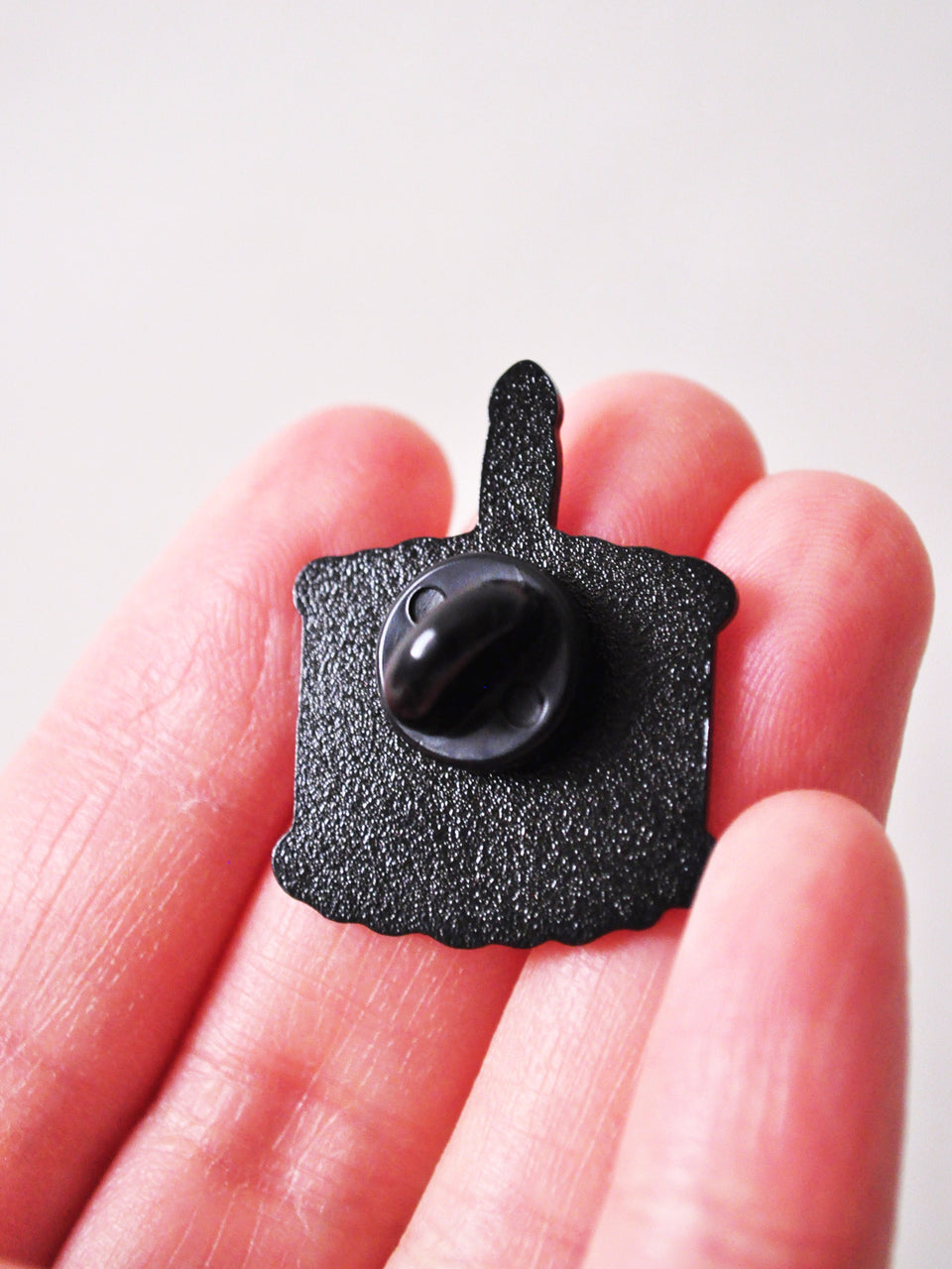 back of birthday cake enamel pin